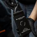 Blackline Pet Hair Brush by Blackline Car Care with black handle and bristles for removing pet hair from surfaces.