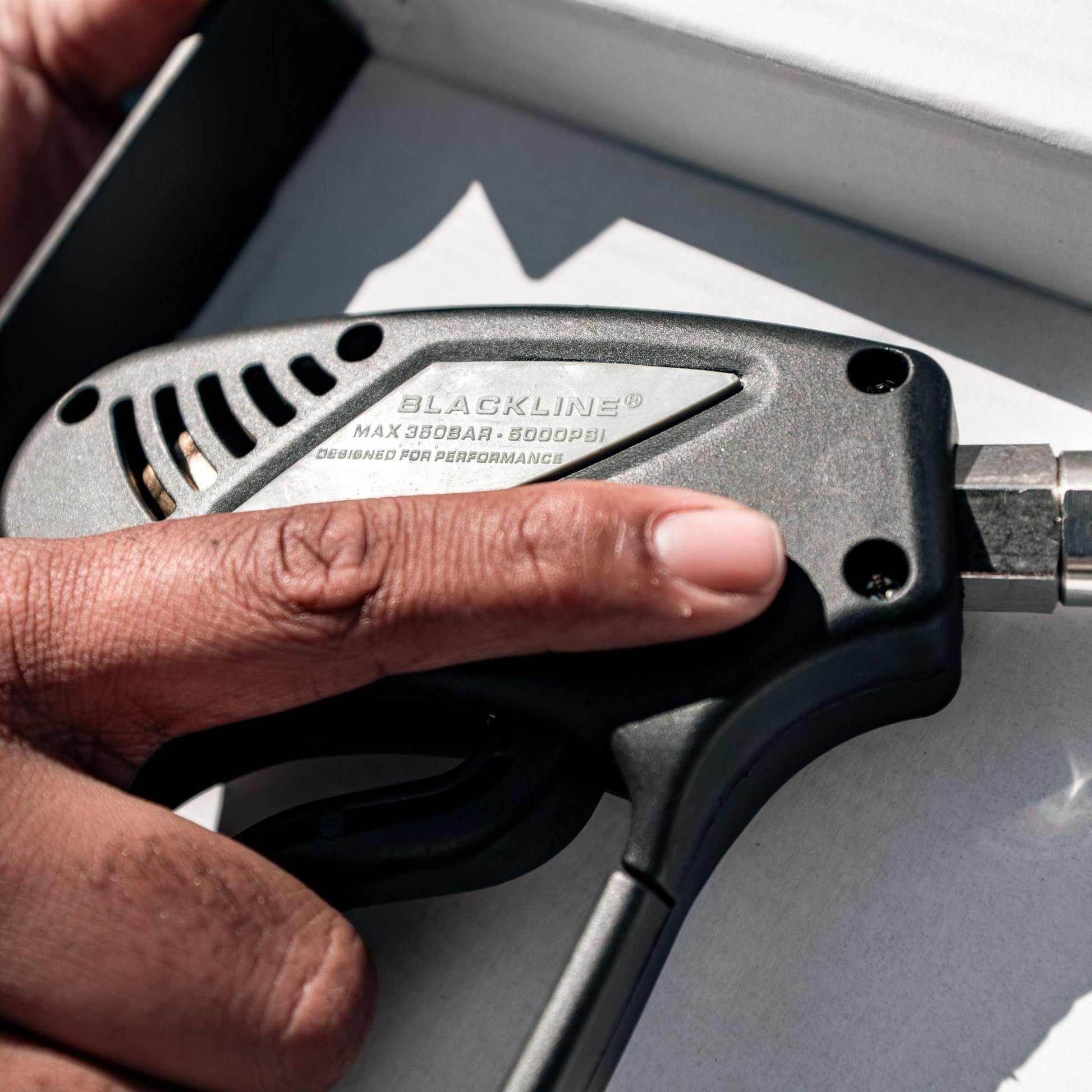 Blackline Car Care black snub-nose pressure washer gun for cleaning and detailing vehicles.