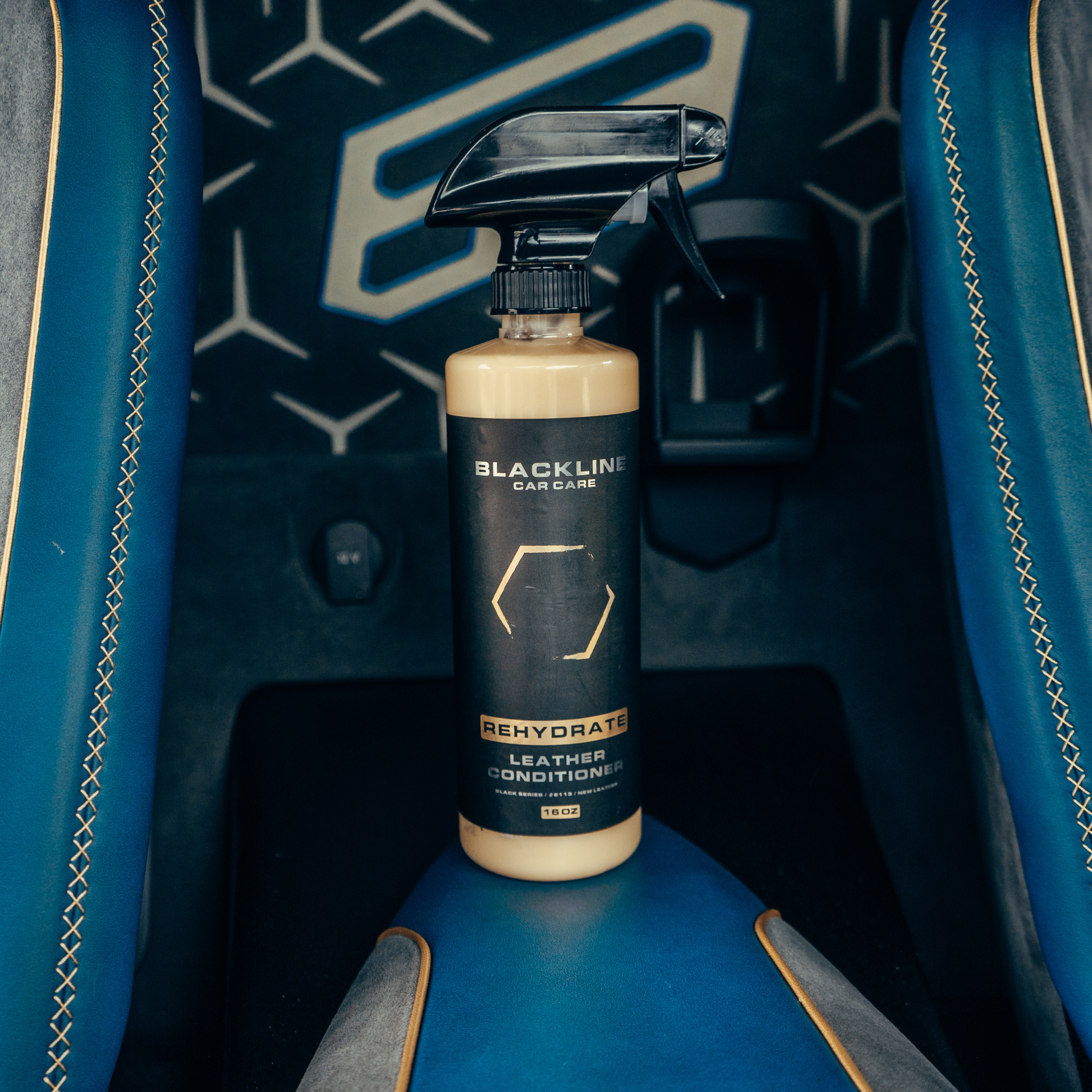 Blackline Car Care BLACKLINE Rehydrate Leather Conditioner in a bottle, designed to nourish and restore leather surfaces.