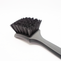 Blackline Car Care stiff bristle tire brush with durable handle for cleaning vehicle tires effectively.