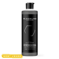 Blackline Car Care BLACKLINE® Blackout Trim & Tire Dressing spray applied to car trim and tires for a sleek, glossy finish.