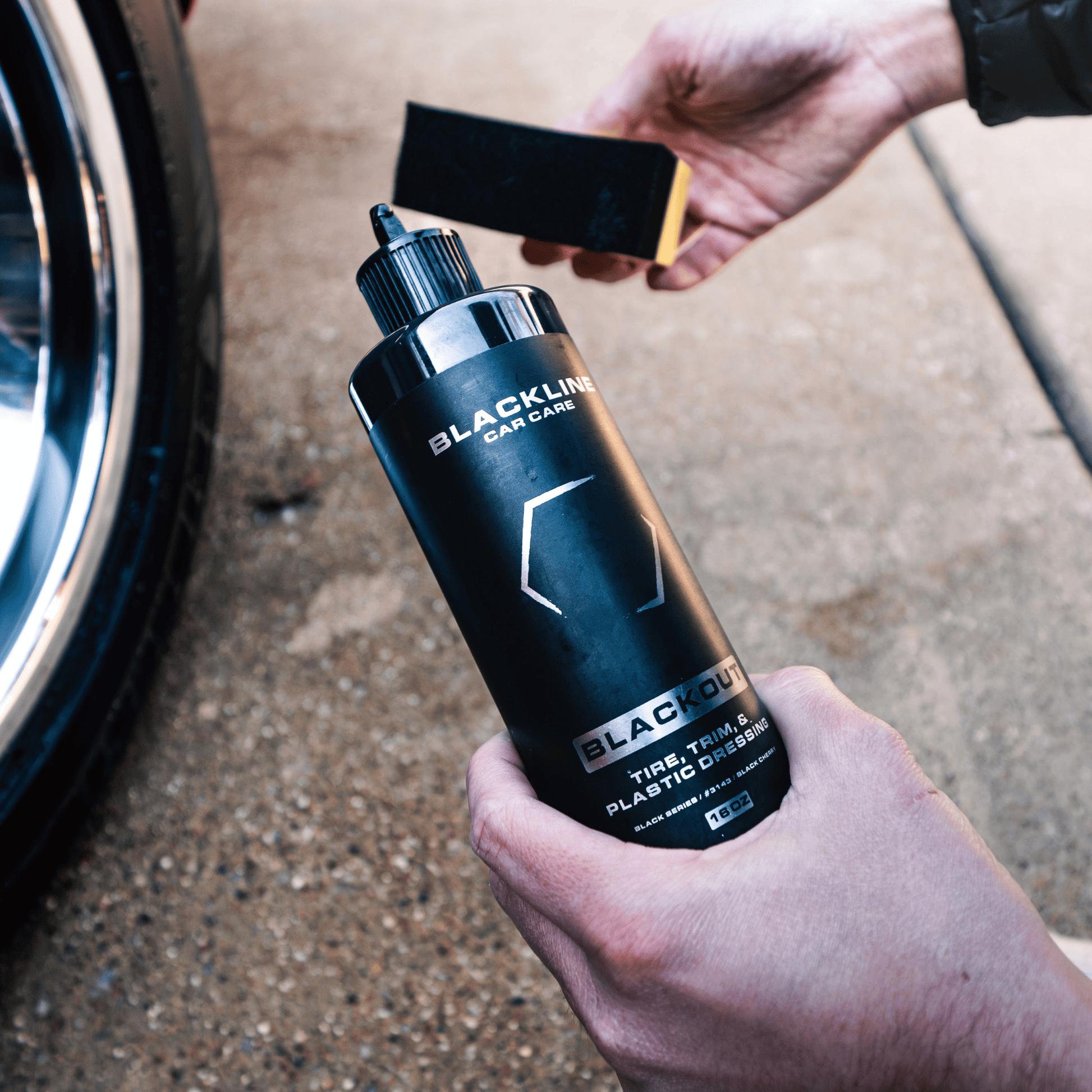 Blackline Car Care BLACKLINE® Blackout Trim & Tire Dressing spray bottle for enhancing trim and tires with a sleek finish.