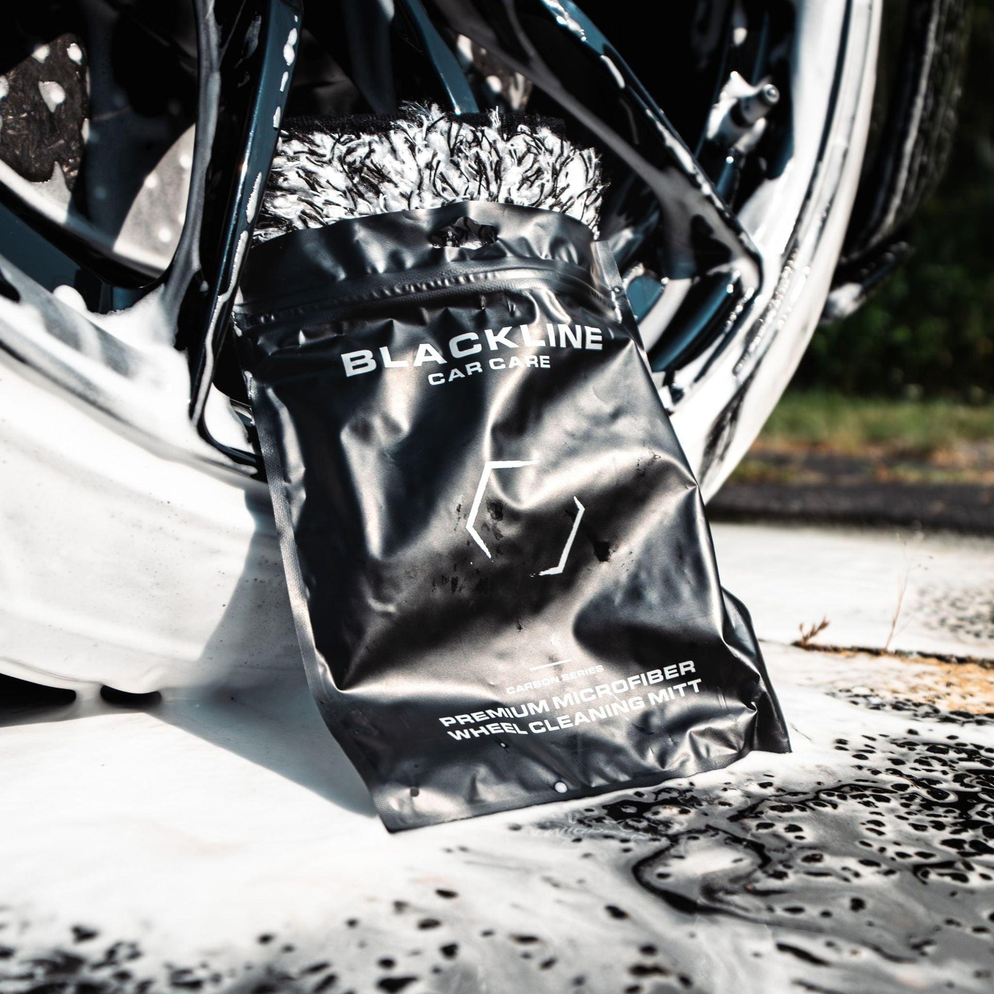 Blackline Car Care microfiber wheel mitt for cleaning car wheels, soft and durable for effective dirt removal.