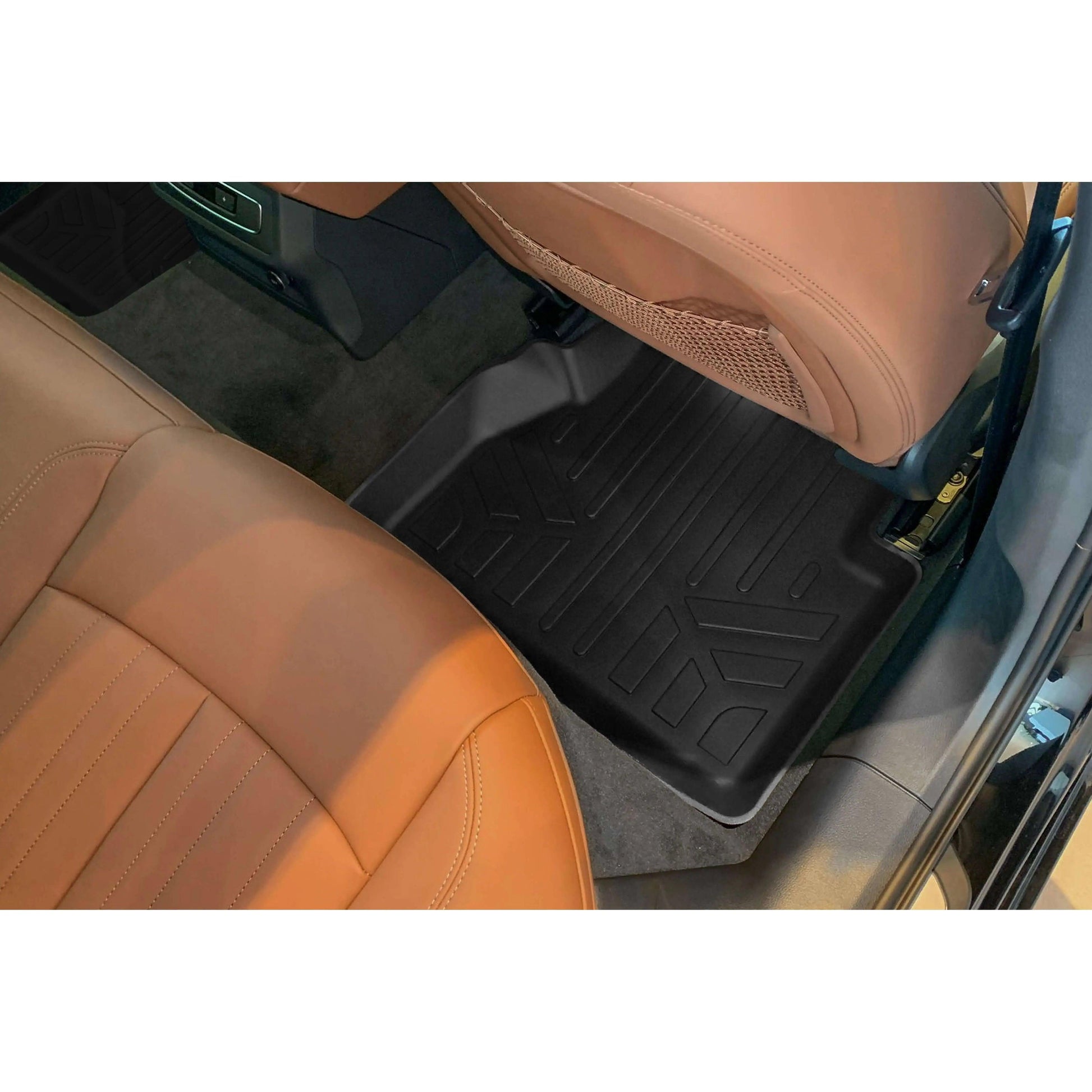 Black custom-fit Audi floor mat in rear seat footwell with tan leather seats