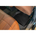 Custom-fit black rear floor mat in luxury car with tan leather seats and clean interior