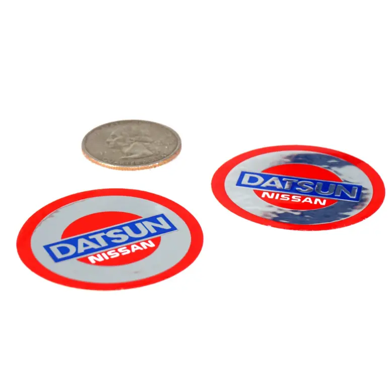 Two vintage style Datsun decals in chrome vinyl by ZSPEC Design, showcasing sleek, retro-inspired sticker designs for car customization.