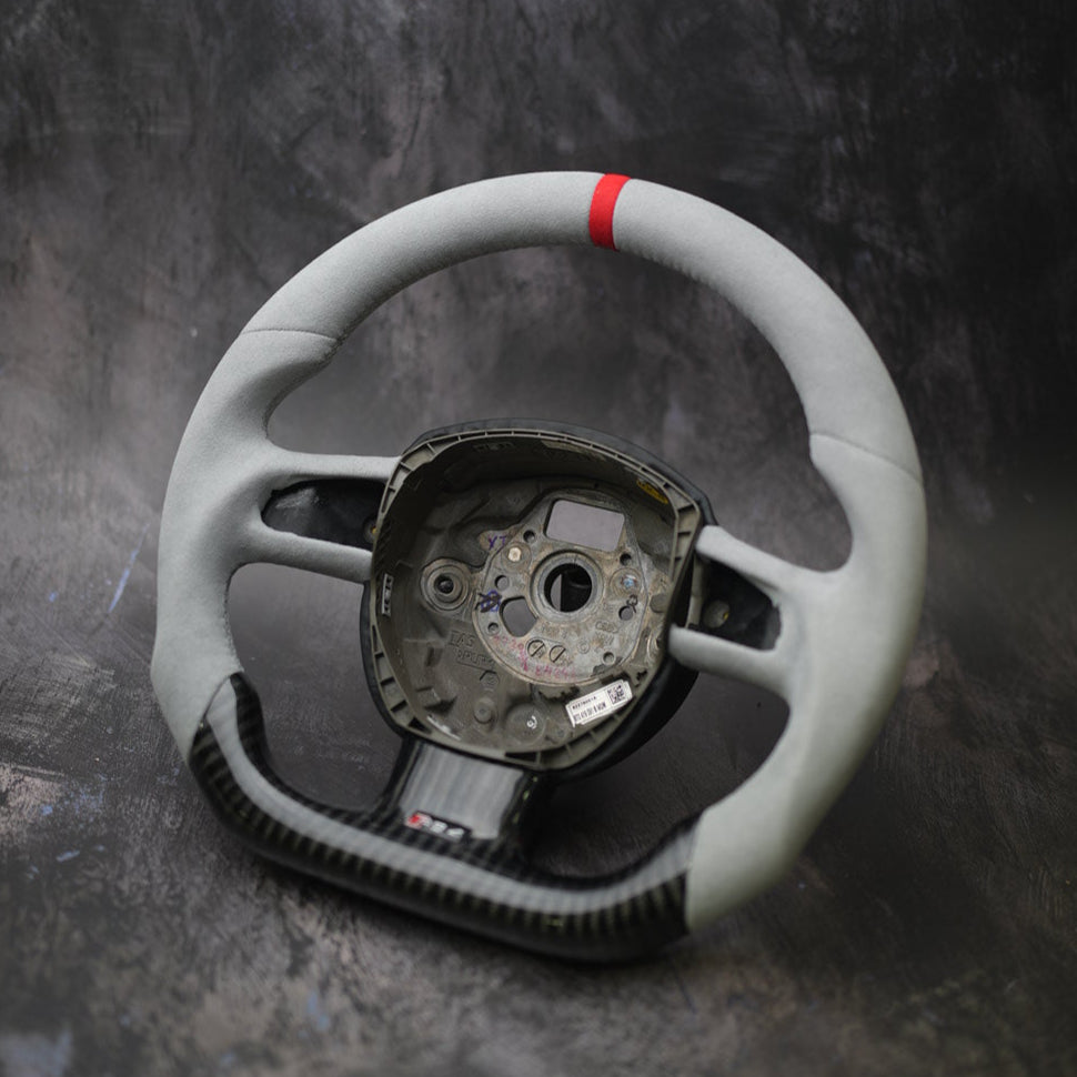 Custom steering wheel for 2005-2011 Audi A3, A4, A5, A6, Q5, Q7, S4, S5 by Exclusive Steering, close-up of leather and control buttons.