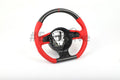 Custom Audi R8 and TT steering wheel by Exclusive Steering, featuring a sleek black leather design with polished accents.