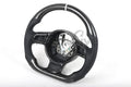Custom Audi R8 and TT steering wheel by Exclusive Steering, black leather with silver accents, mounted on a car dashboard.