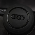 Custom black leather steering wheel for Audi A3 to RS7 models by Exclusive Steering, featuring ergonomic design and premium finish.