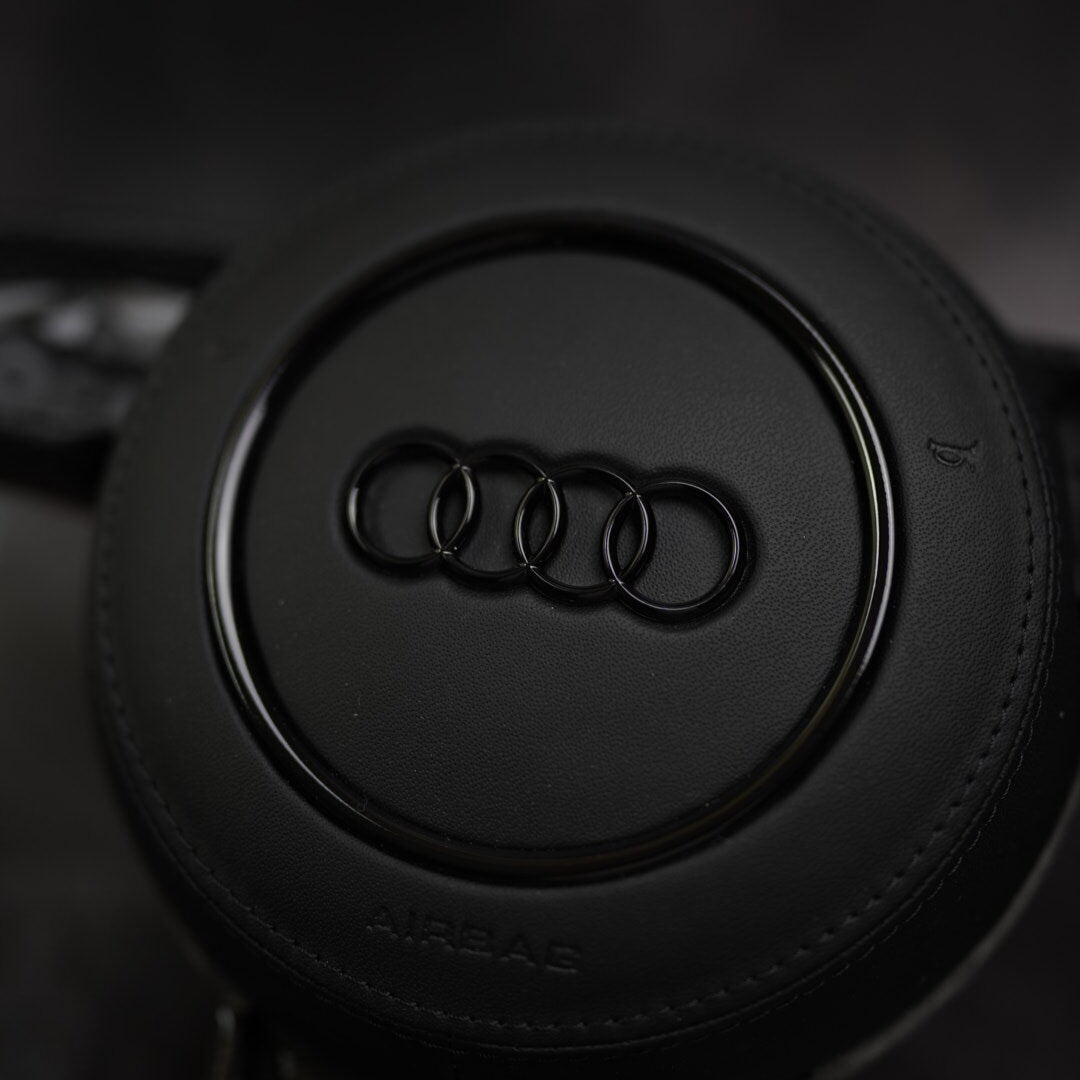 Custom black leather steering wheel for Audi A3 to RS7 models by Exclusive Steering, featuring ergonomic design and premium finish.