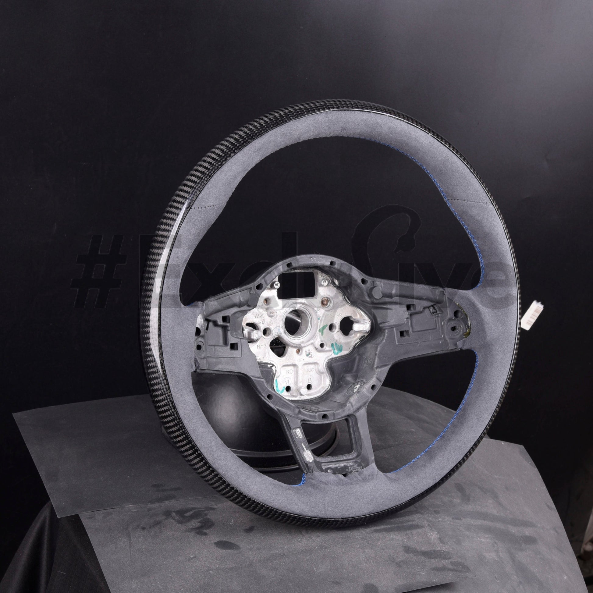 Volkswagen Golf MK7 GTI & R custom steering wheel by Exclusive Steering, black leather with red stitching and sporty design.
