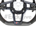 Custom Audi R8 and TT steering wheel by Exclusive Steering, featuring a sleek leather grip and detailed stitching.