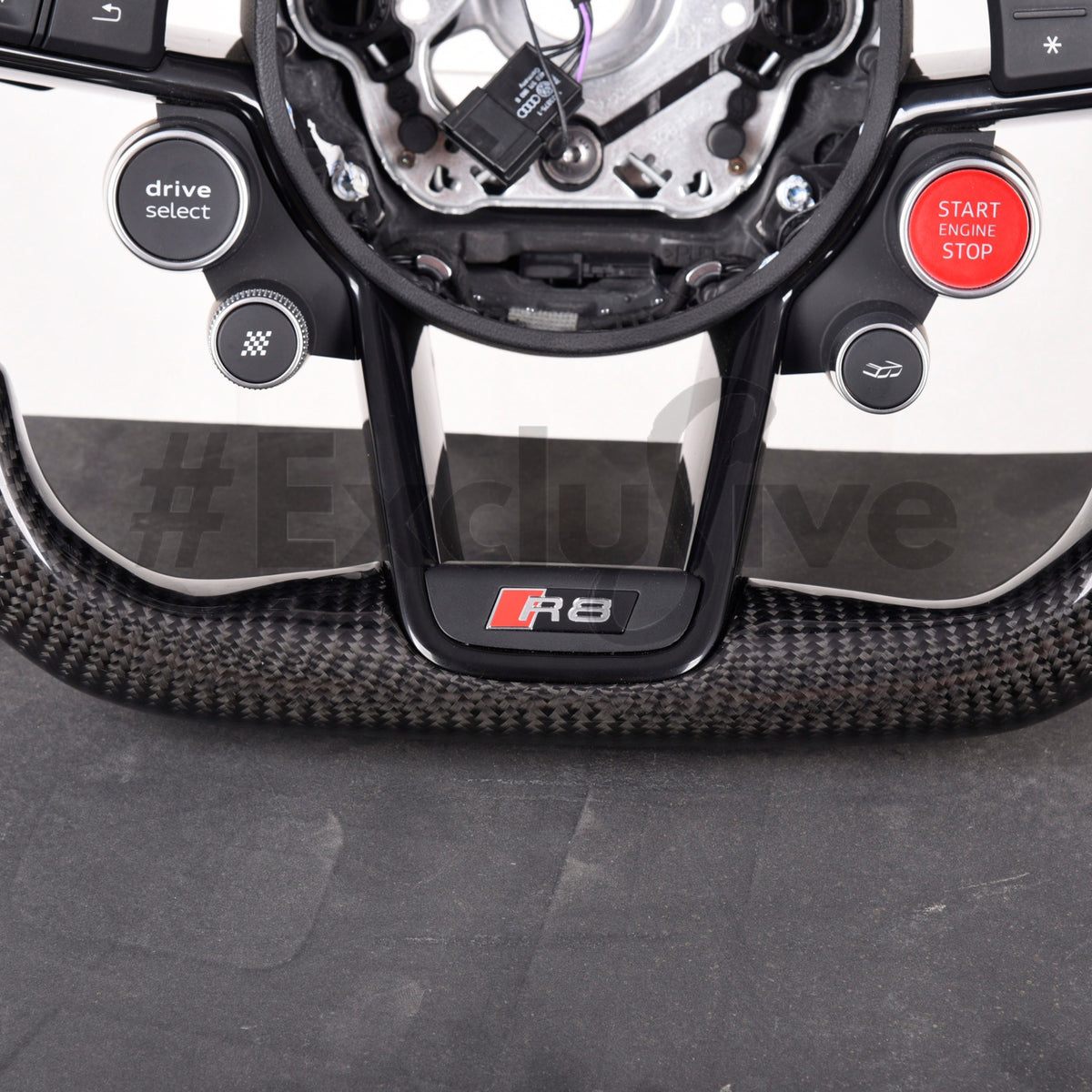 Custom Audi R8/TT steering wheel by Exclusive Steering, featuring detailed leather and stitching for a luxurious interior upgrade.