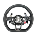 Audi R8 and TT custom steering wheel by Exclusive Steering, featuring a sleek leather-wrapped design with detailed stitching.