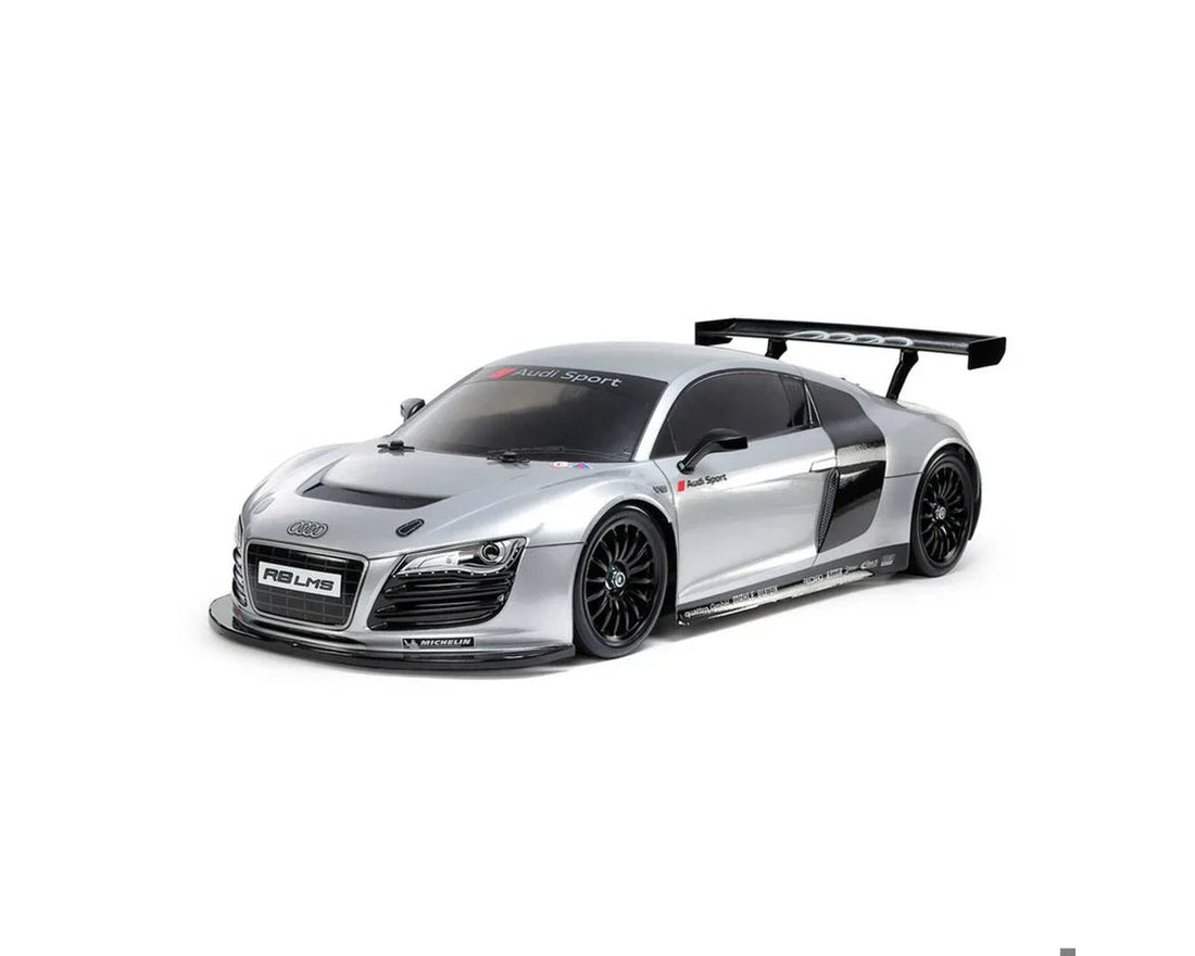 Silver Audi R8 LMS race car with large rear wing and Michelin branding