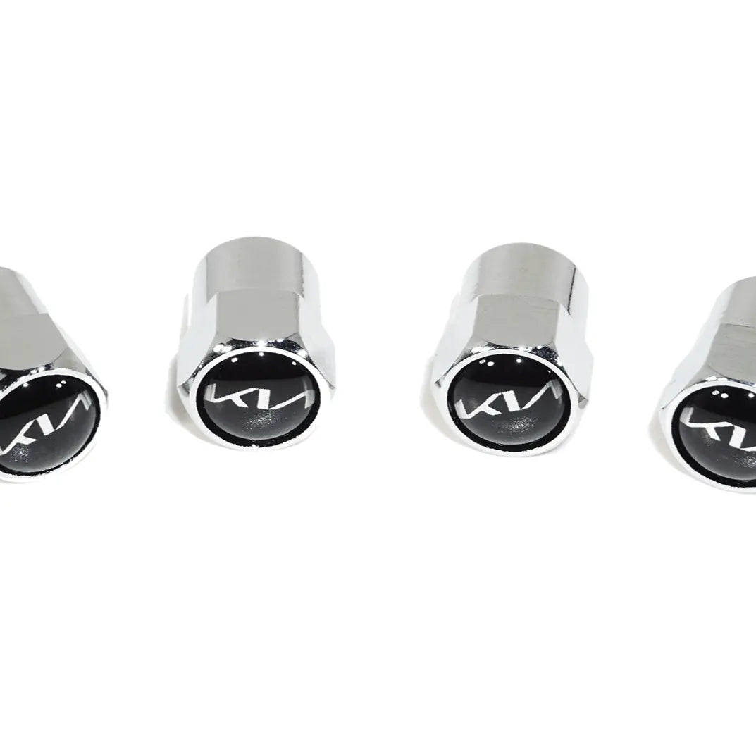 Set of four chrome Kia tire valve stem caps with black logo on white background