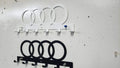 Steel wall-mounted Audi logo keychain rack by Martin Metalwork LLC, designed for organizing keys with an orange Audi emblem.