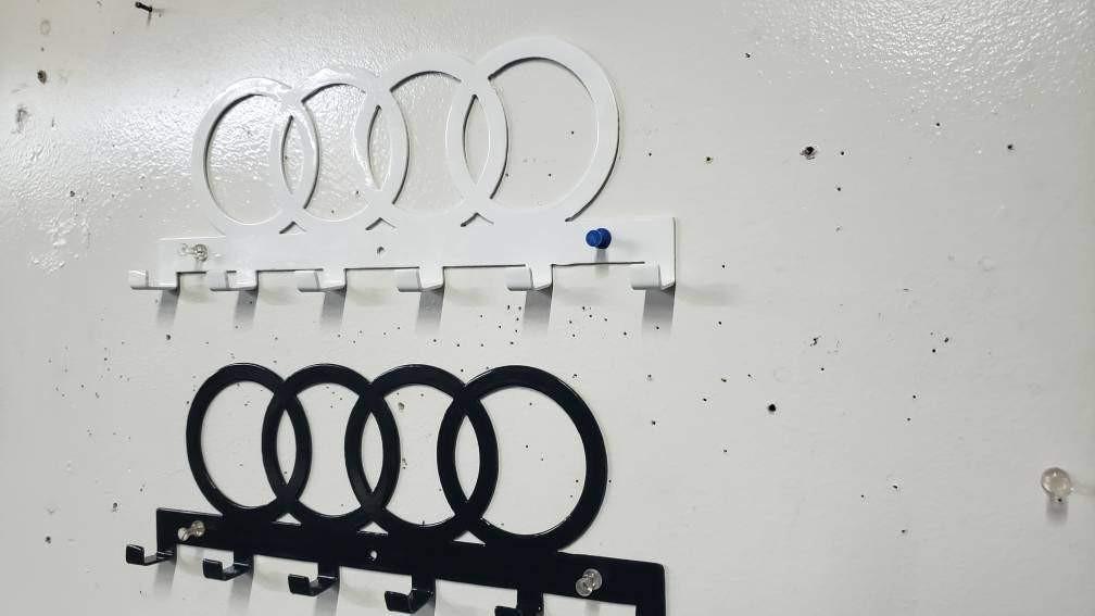 Steel wall-mounted Audi logo keychain rack by Martin Metalwork LLC, designed for organizing keys with an orange Audi emblem.