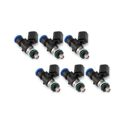 Set of four MOTIV Injector Dynamics ID1050XDS fuel injectors with metal bodies and electrical connectors.