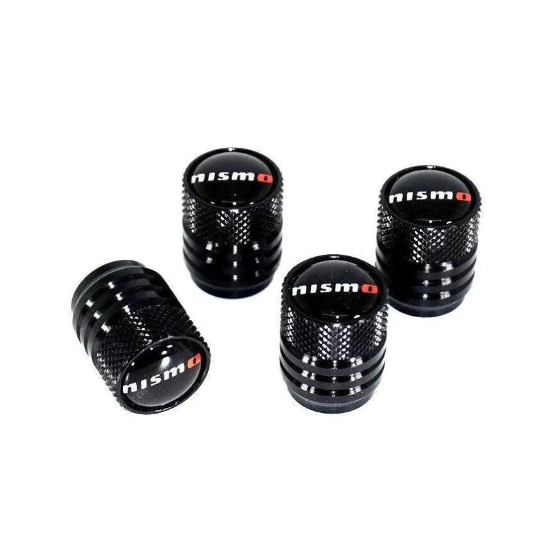 NISMO Nissan tire valve stem cap set in black, featuring four sleek, durable caps designed for vehicle wheel valve protection.