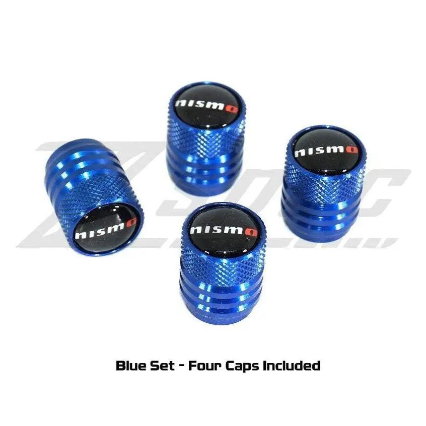 Blue NISMO Nissan tire valve stem cap set with four matching caps, featuring the NISMO logo for a stylish car accessory.