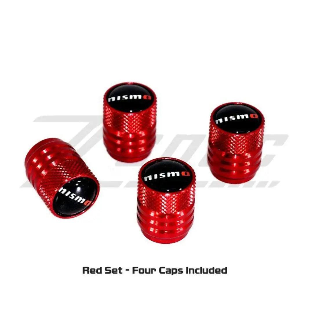 Red NISMO tire valve stem cap set for Nissan vehicles, featuring durable metal caps with NISMO branding.