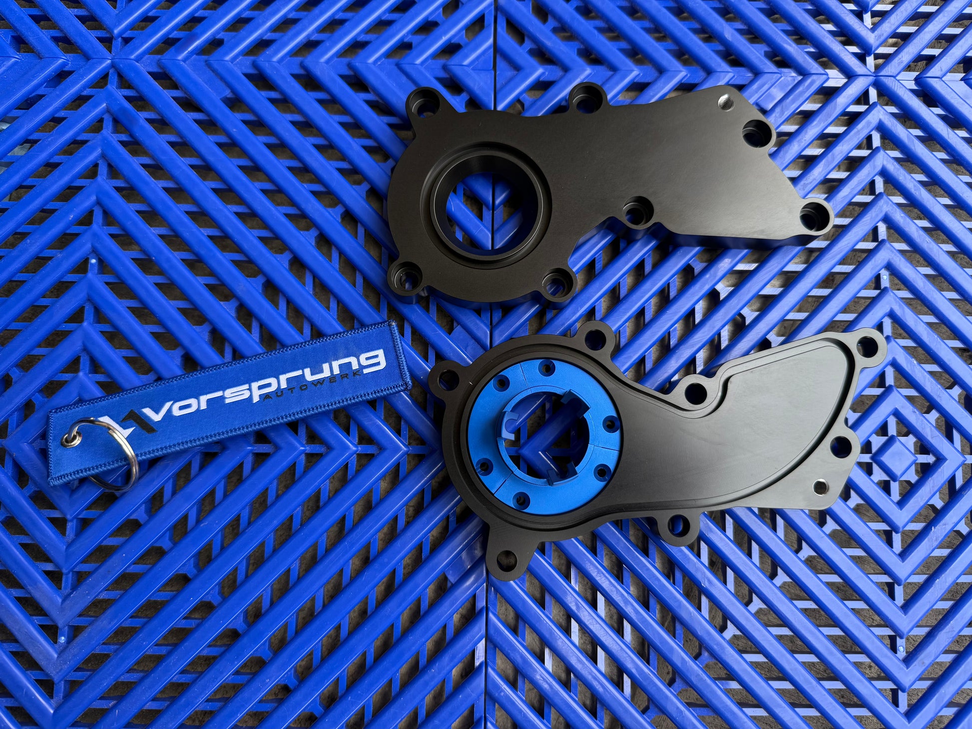 Bespoke Audi performance parts with blue accents on a geometric blue background