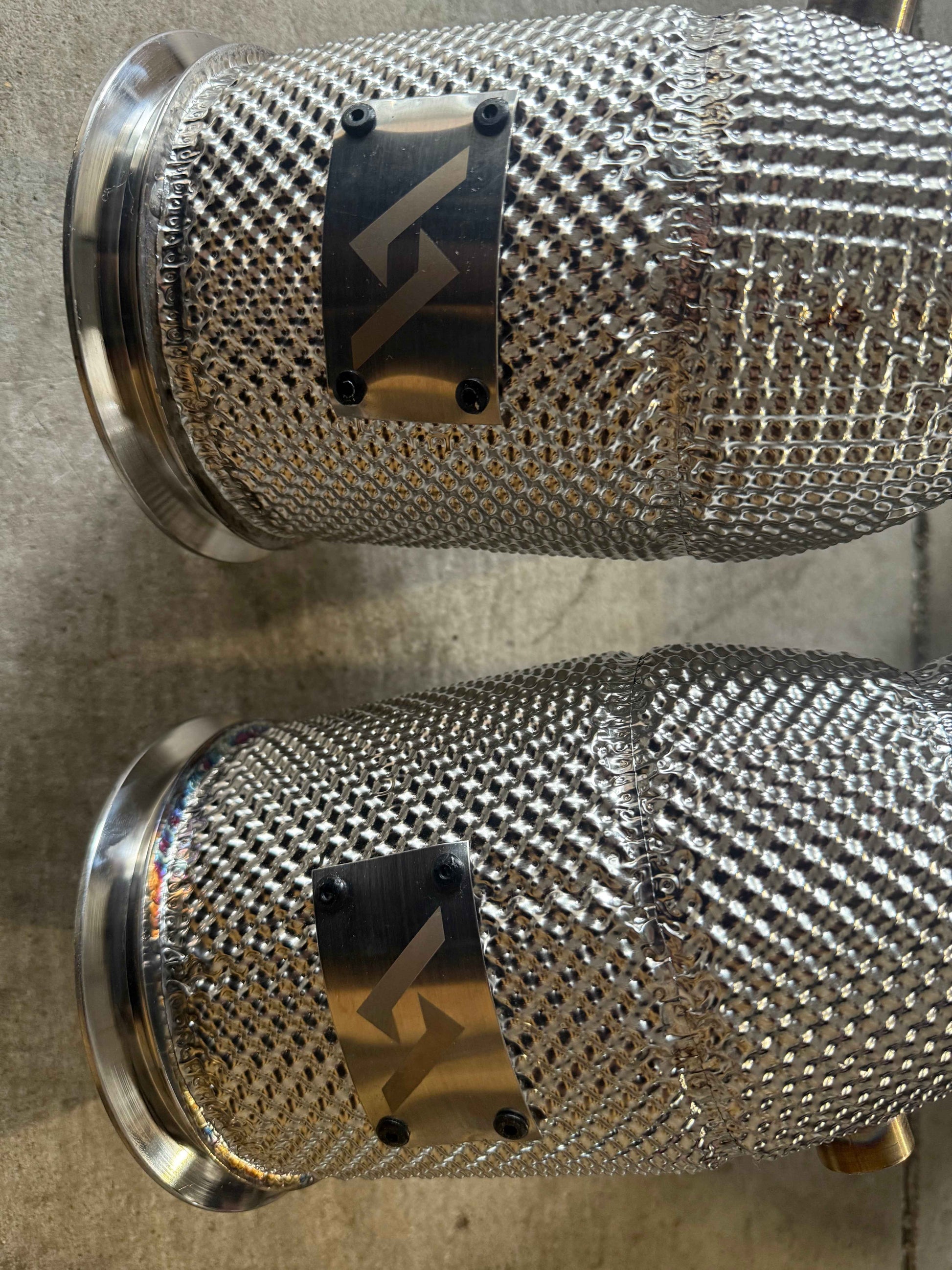 High-performance Audi intercooler pipes with braided mesh and custom logo plates for enhanced airflow and power