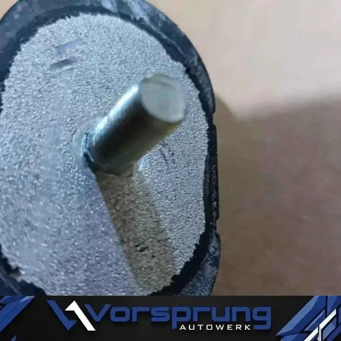 Close-up of Audi B8.5 B9 transmission upgrade mount with metal rod and textured surface
