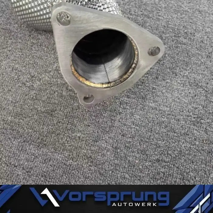High-flow catalytic converter for Audi 3.0T V6 supercharged, close-up on grey fabric.