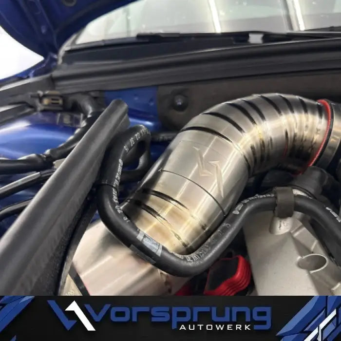 Titanium intake pipe installed in Audi S4 engine bay, with visible heat marks and hoses