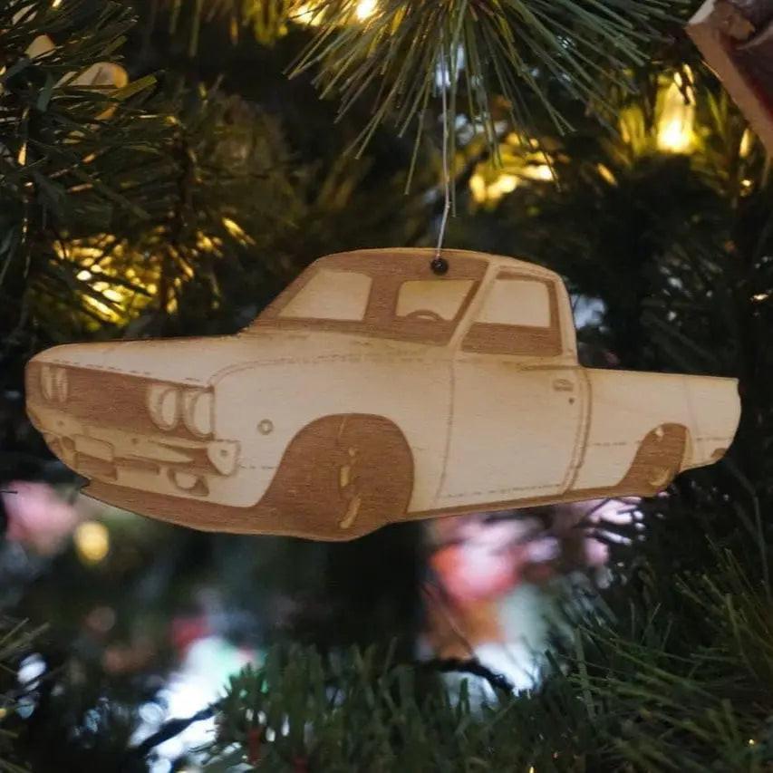 Laser-engraved birch ornament featuring a Datsun 620 truck design, approximately 5 inches wide, by ZSPEC Design.