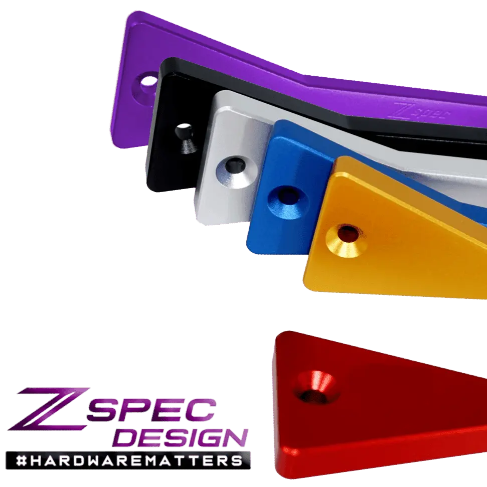 Red billet ZSPEC battery hold down bracket with stainless hardware for Datsun Z and ZX cars, designed for secure engine bay mounting.